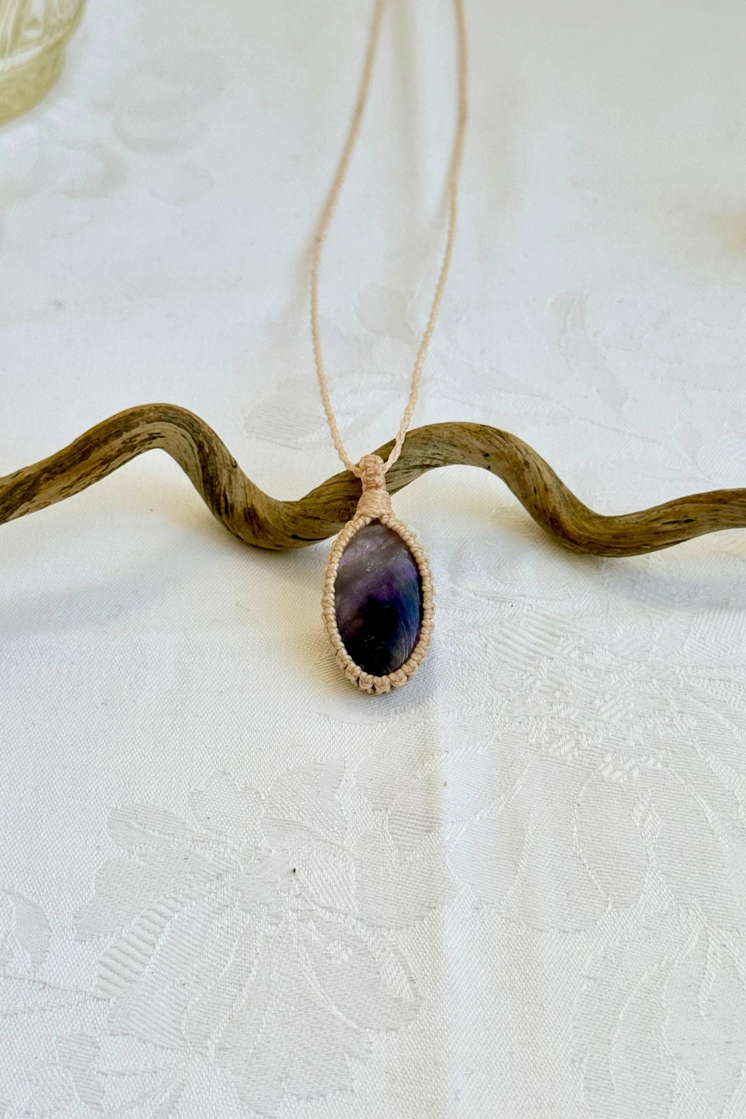 Handmade Chevron Amethyst Macrame necklace featuring a high-quality gemstone, laid flat to showcase its delicate everyday-wear design from the Essence collection.