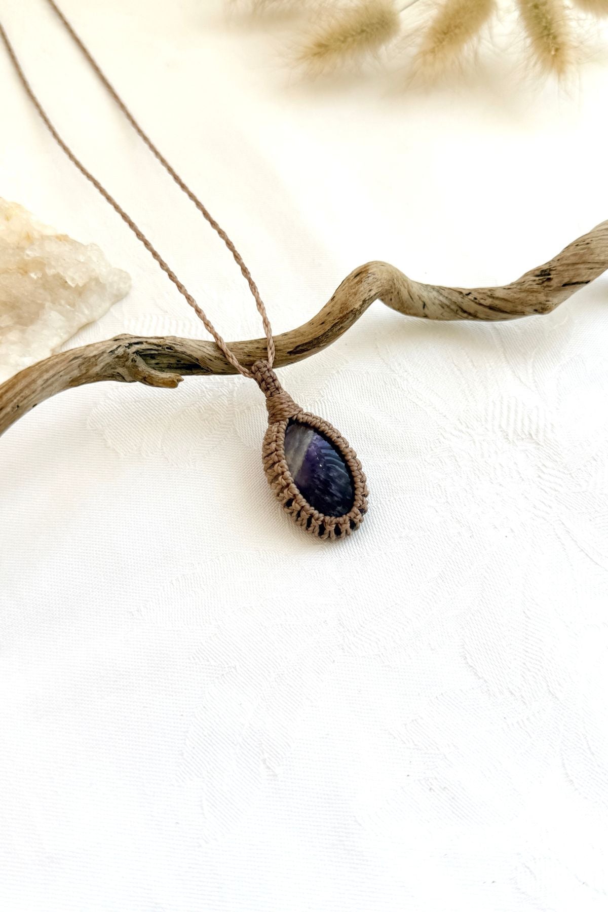 Handmade Chevron Amethyst macramé necklace, side view showing the gemstone and macramé knotting