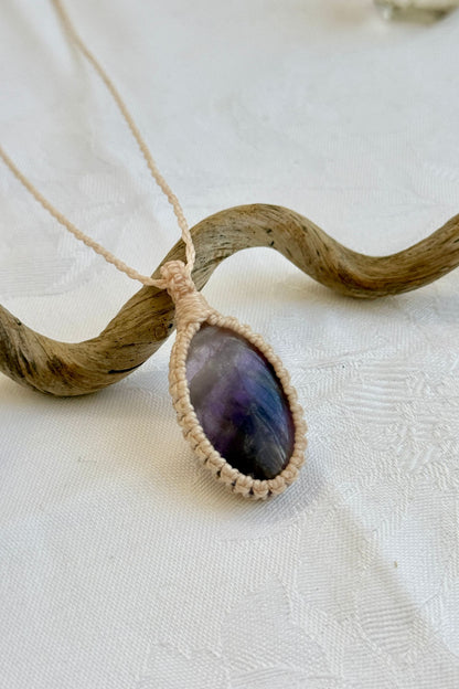 Close-up of handmade Chevron Amethyst Macrame necklace, showcasing the intricate macrame knotting and the vibrant patterns of the gemstone.