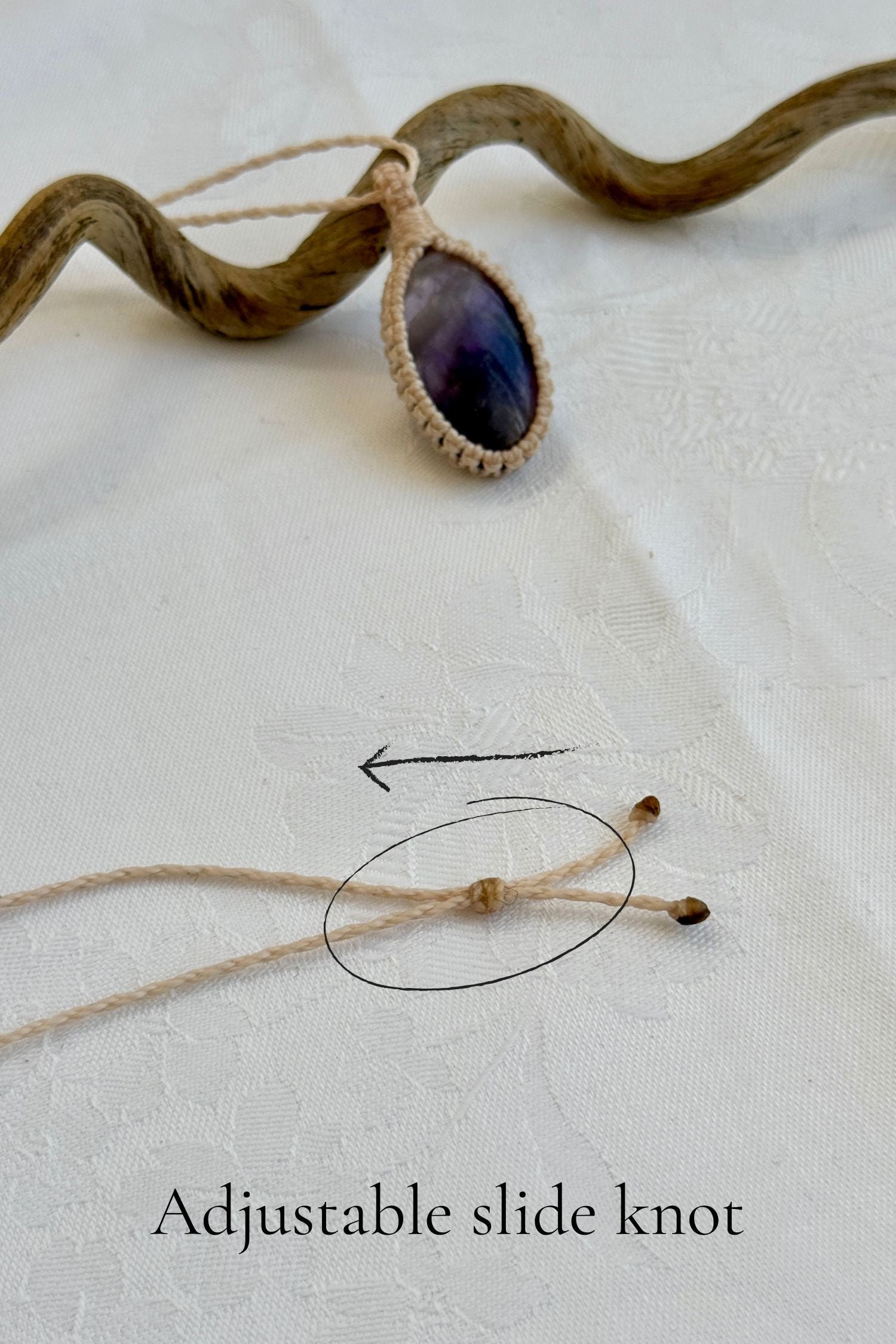 Close-up of the adjustable sliding knot on the Chevron Amethyst Macrame necklace, allowing for an easy and customizable fit for any wearer.