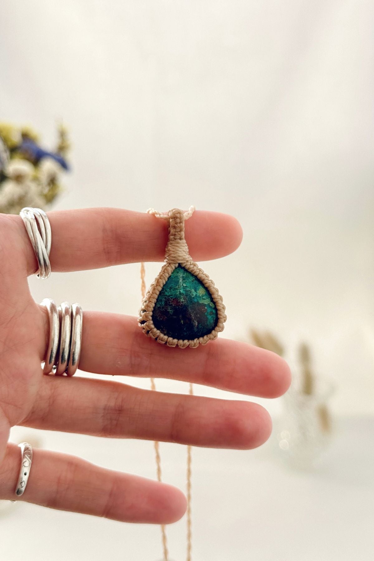 Handmade Chrysocolla macramé necklace held in hand, delicate natural gemstone jewelry