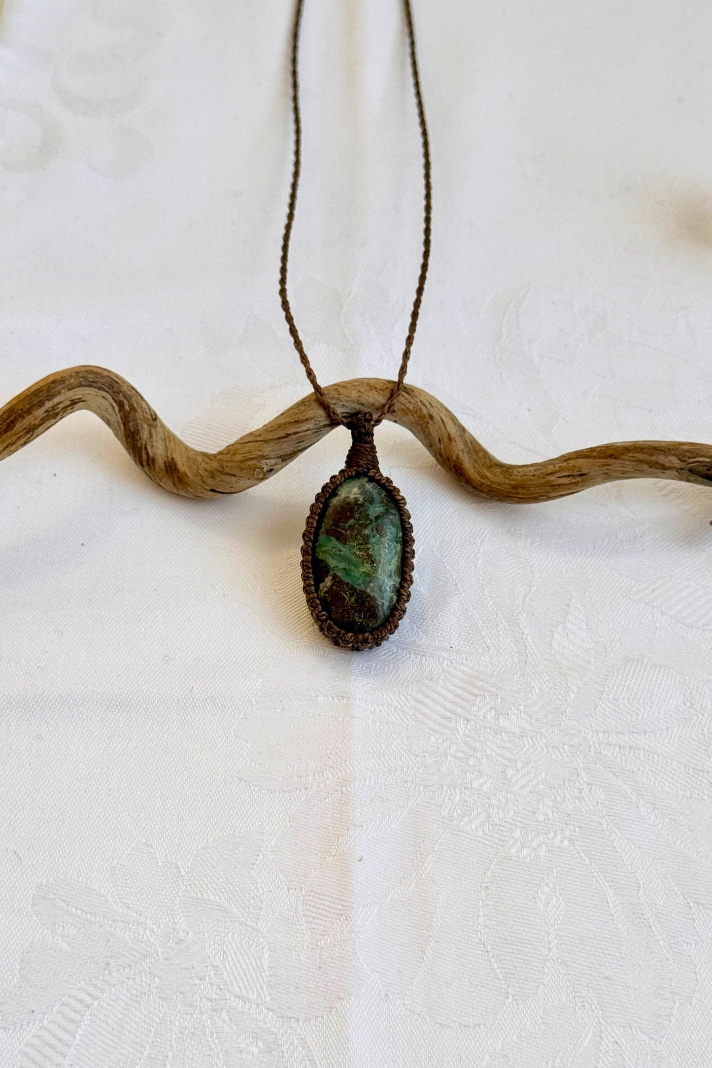 Handmade Chrysocolla Macrame necklace featuring a high-quality gemstone, laid flat to showcase its delicate everyday-wear design from the Essence collection.