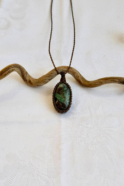 Handmade Chrysocolla Macrame necklace featuring a high-quality gemstone, laid flat to showcase its delicate everyday-wear design from the Essence collection.
