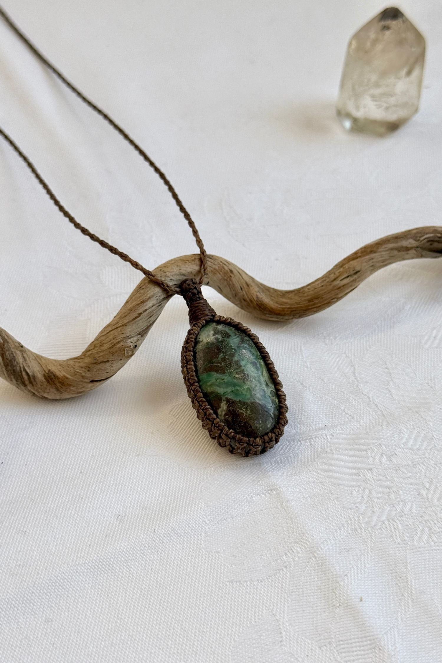 Another side angle shot of the handmade Chrysocolla Macrame necklace, emphasizing the elegant craftsmanship and natural gemstone colors.