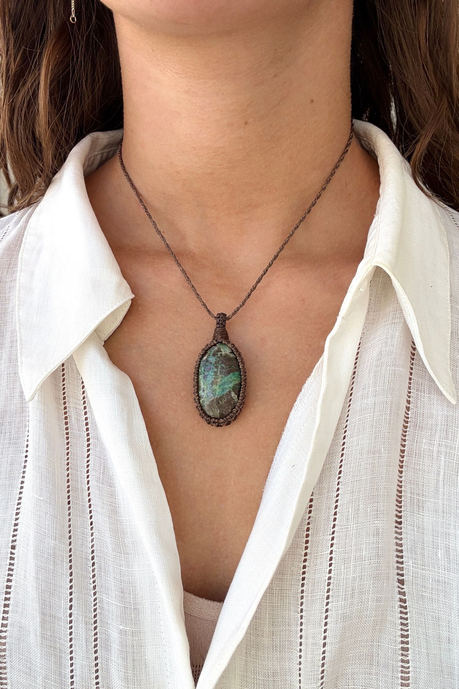 Model wearing a delicate handmade Chrysocolla macrame necklace with a brown cord, perfect for everyday wear.
