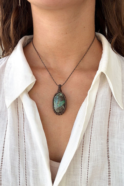 Model wearing a delicate handmade Chrysocolla macrame necklace with a brown cord, perfect for everyday wear.