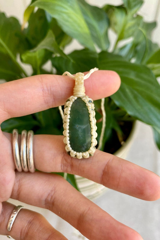 Hand holding a handmade Chrysoprase macrame necklace, showcasing the deep green forest hues of the gemstone with subtle natural patterns.