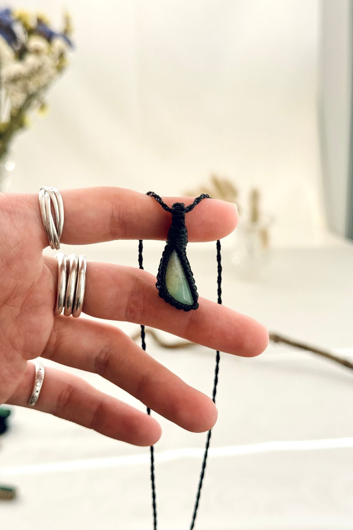 Handmade Chrysoprase macramé necklace held in hand, delicate natural gemstone jewelry