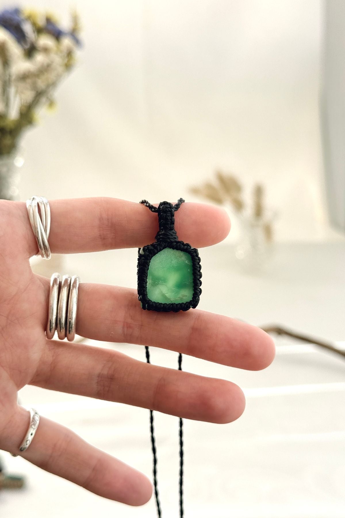 Handmade Chrysoprase macramé necklace held in hand, delicate natural gemstone jewelry