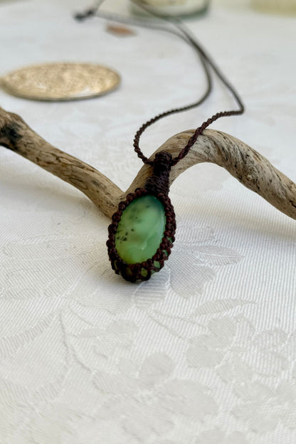 Alternate side view of a handmade Chrysoprase macrame necklace, focusing on the gemstone’s natural glow.