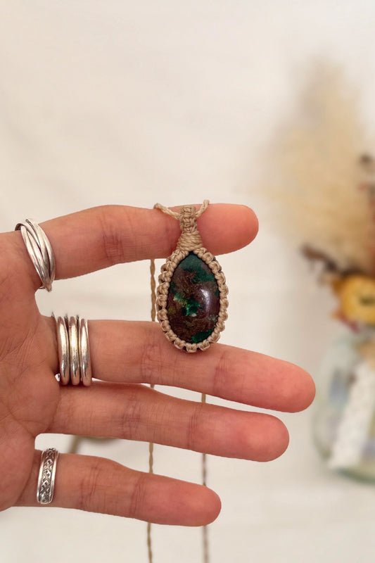 Hand holding a handmade Chrysocolla Macrame necklace from the Essence collection, featuring a high-quality gemstone in a delicate everyday-wear design.