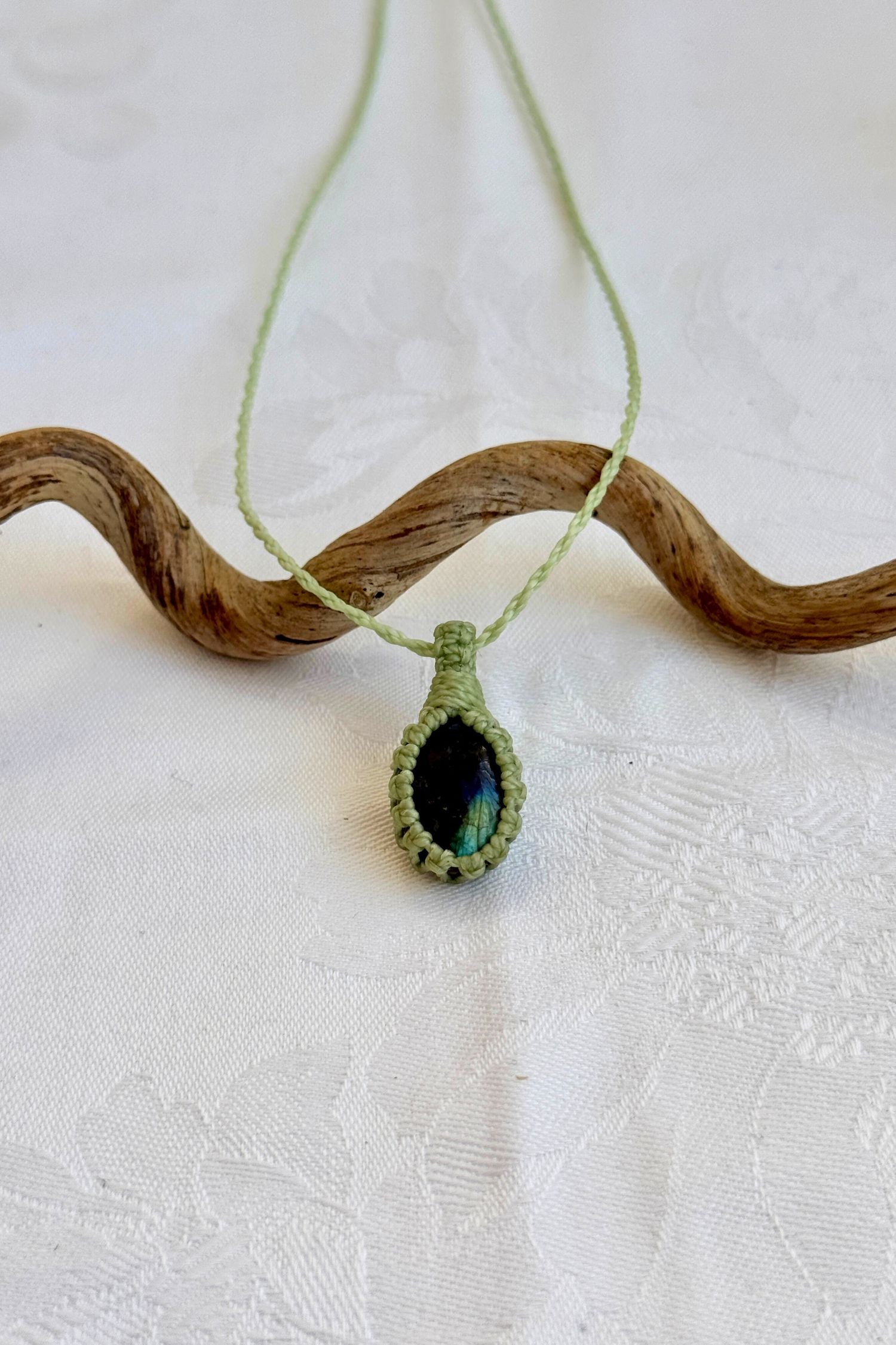 Handmade Labradorite Macrame necklace featuring a high-quality gemstone, laid flat to showcase its delicate everyday-wear design from the Essence collection.