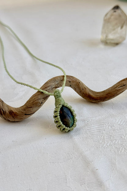 Close-up of handmade Labradorite Macrame necklace, showcasing the intricate macrame knotting and the vibrant patterns of the gemstone.