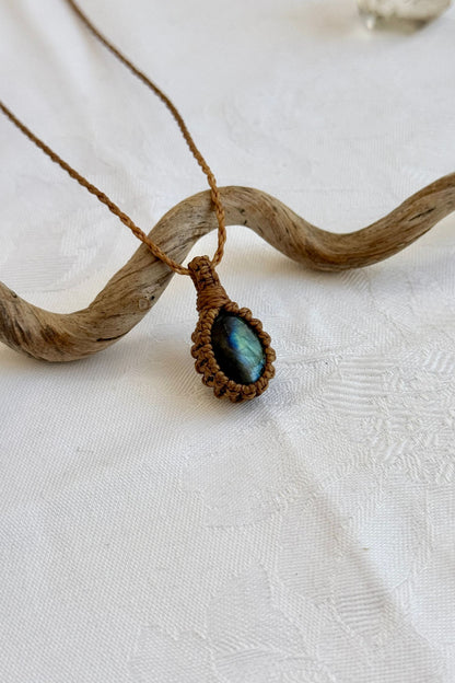 Close-up of handmade Labradorite Macrame necklace, showcasing the intricate macrame knotting and the vibrant patterns of the gemstone.