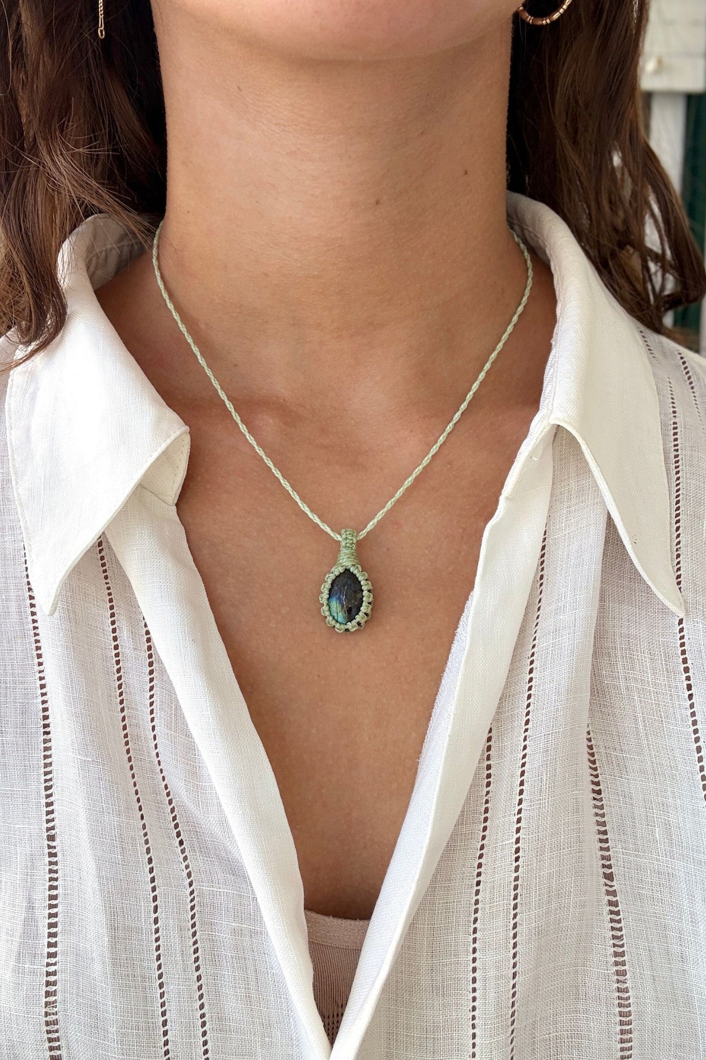 Model wearing a delicate handmade Labradorite macrame necklace with a mint green cord, perfect for everyday wear.