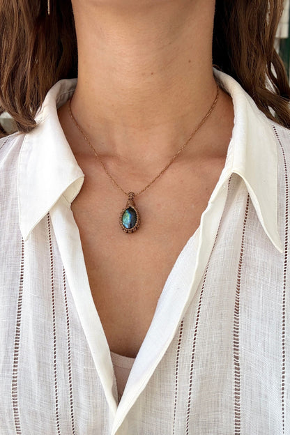 Model wearing a delicate handmade Labradorite macrame necklace with a brown cord, perfect for everyday wear.