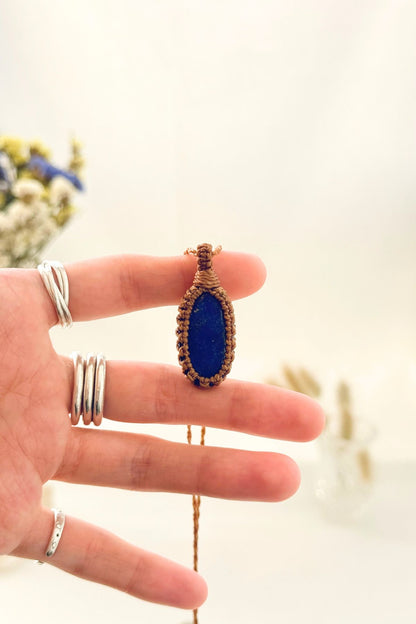 Handmade Lapis Lazuli macramé necklace held in hand, delicate natural gemstone jewelry