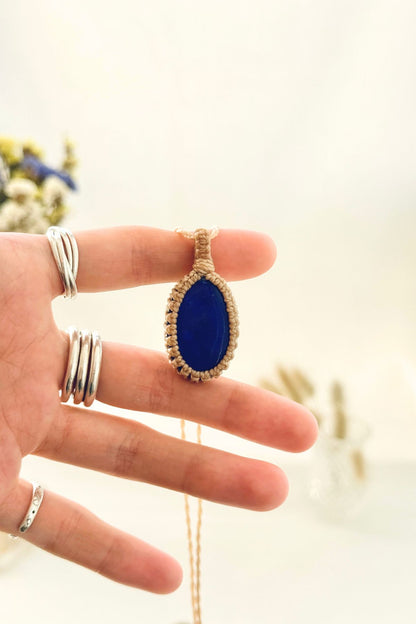 Handmade Lapis Lazuli macramé necklace held in hand, delicate natural gemstone jewelry