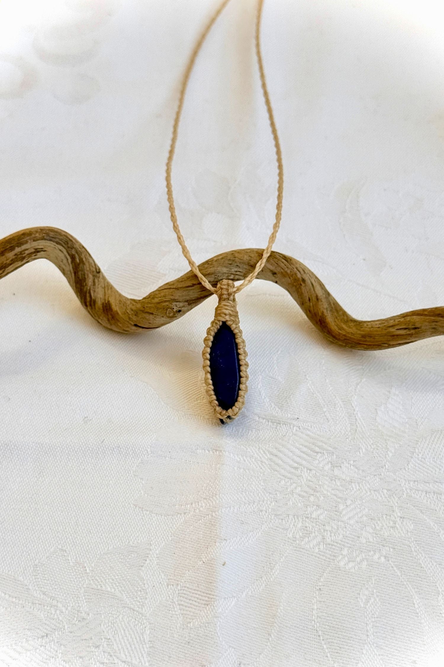 Handmade Lapis Lazuli Macrame necklace featuring a high-quality gemstone, laid flat to showcase its delicate everyday-wear design from the Essence collection.