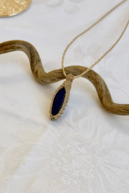 Side angle view of the Lapis Lazuli Macrame necklace, showing the fine macrame details and the unique gemstone centerpiece.