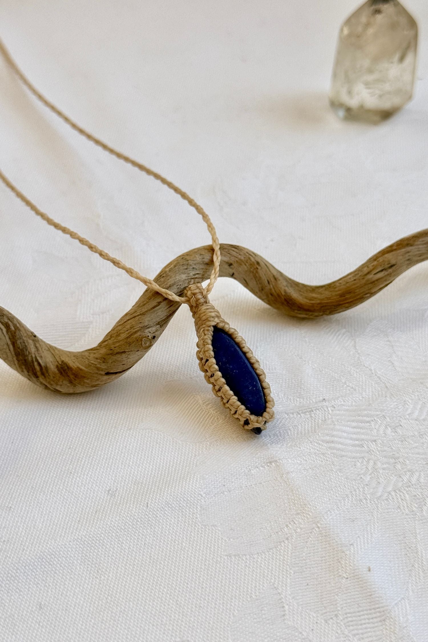 Close-up of handmade Lapis Lazuli Macrame necklace, showcasing the intricate macrame knotting and the vibrant patterns of the gemstone.
