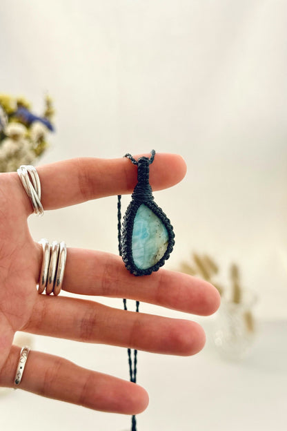 Handmade Larimar macramé necklace held in hand, delicate natural gemstone jewelry