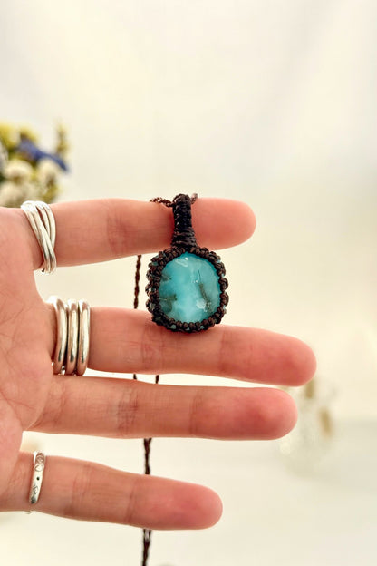 Handmade Larimar macramé necklace held in hand, delicate natural gemstone jewelry