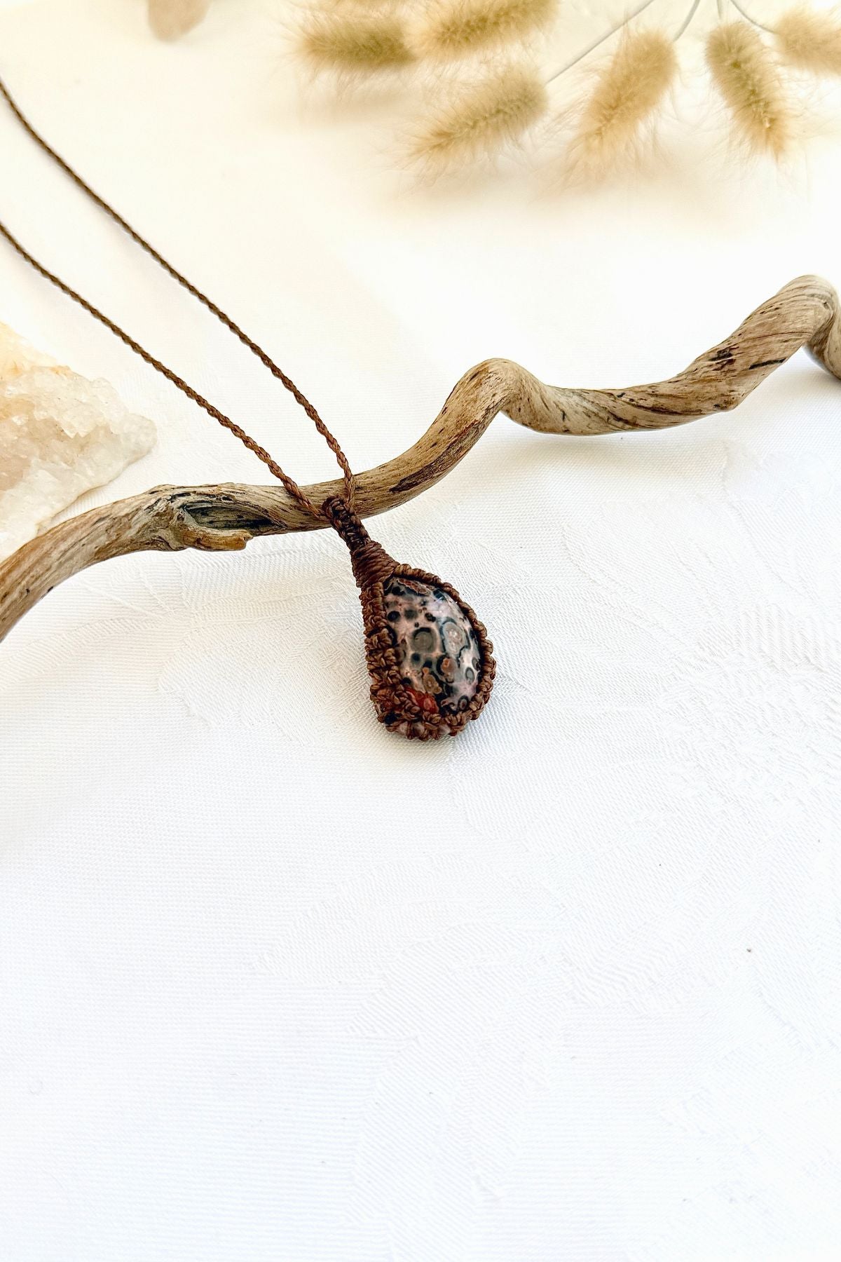 Handmade Leopard Jasper macramé necklace, side view showing the gemstone and macramé knotting