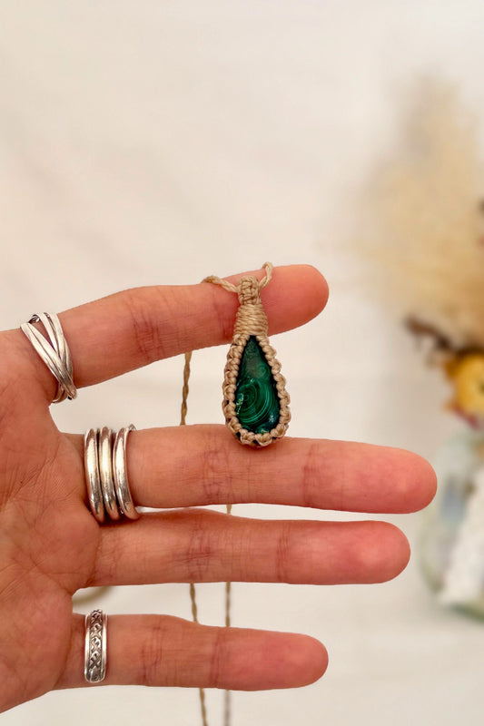 Hand holding a handmade Malachite Macrame necklace from the Essence collection, featuring a high-quality gemstone in a delicate everyday-wear design.