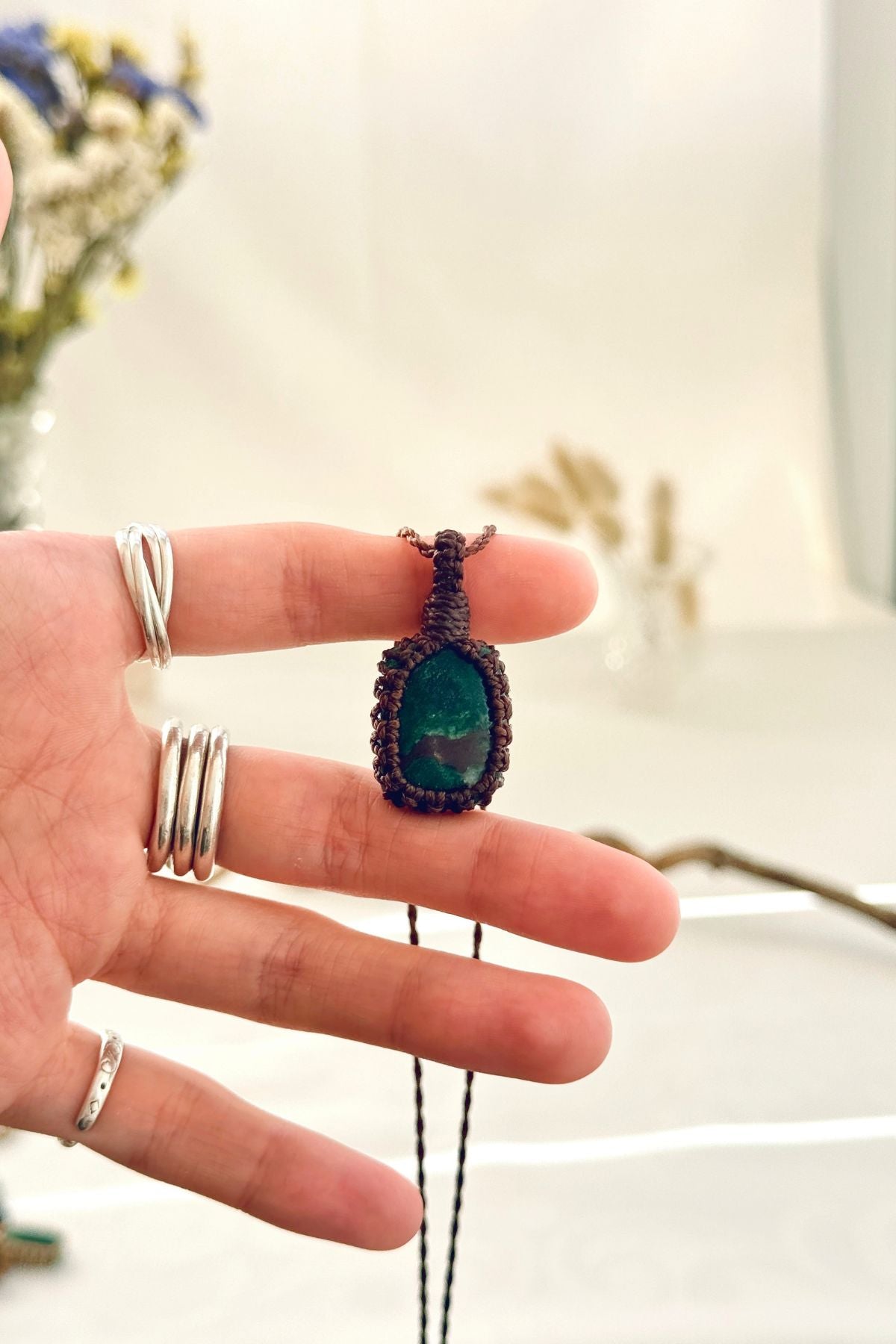 Handmade Malachite macramé necklace held in hand, delicate natural gemstone jewelry