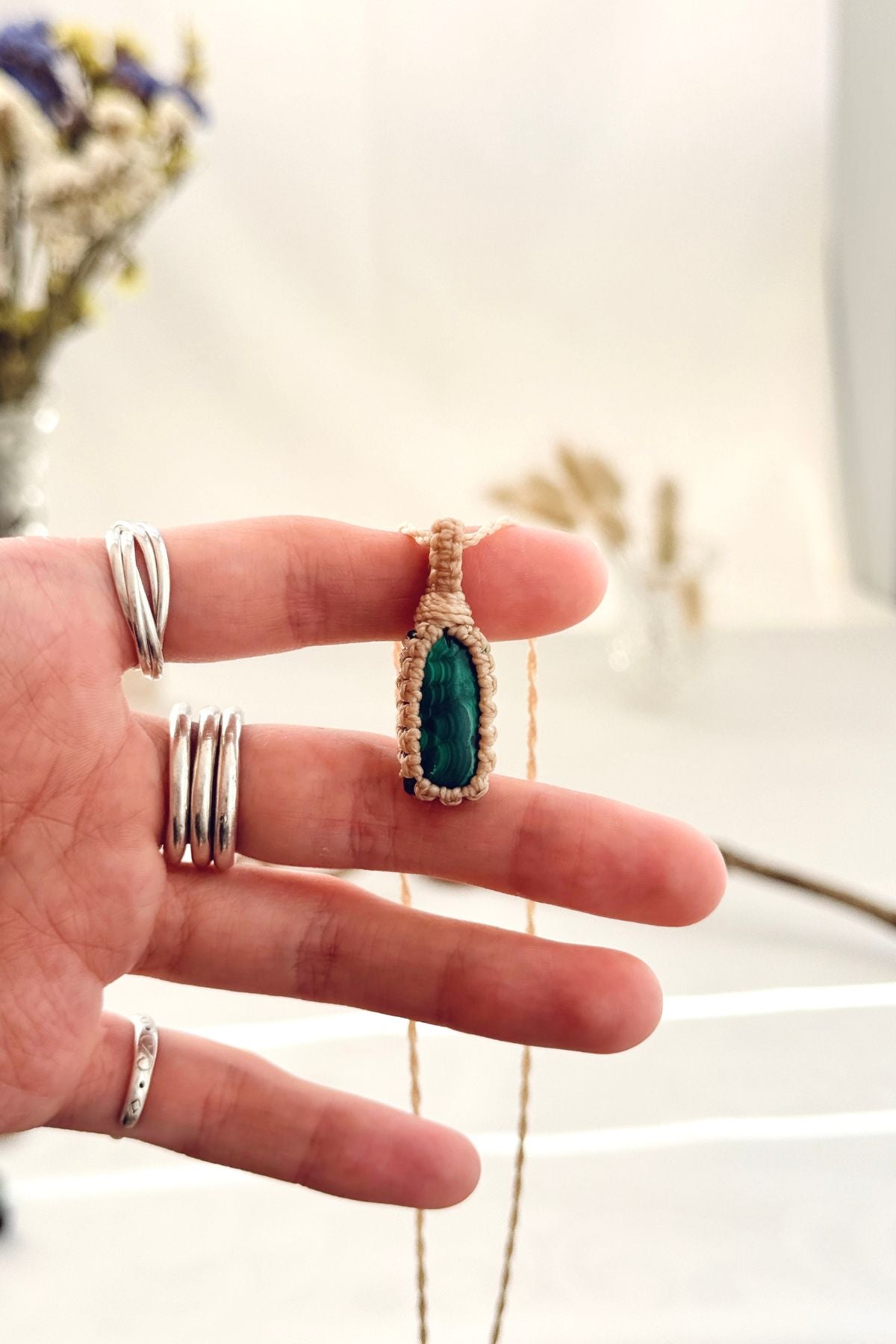 Handmade Malachite macramé necklace held in hand, delicate natural gemstone jewelry
