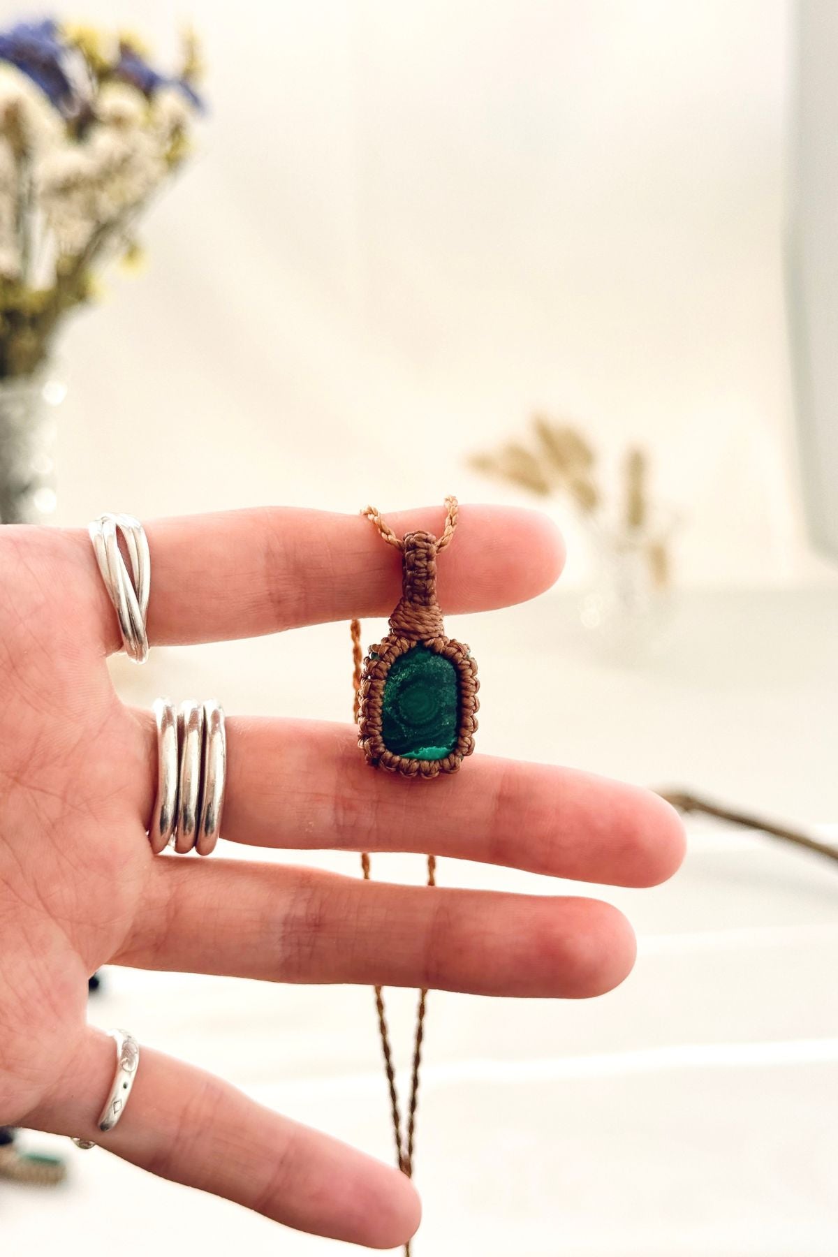 Handmade Malachite macramé necklace held in hand, delicate natural gemstone jewelry