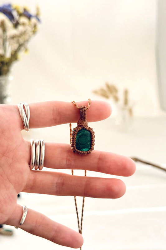 Handmade Malachite macramé necklace held in hand, delicate natural gemstone jewelry