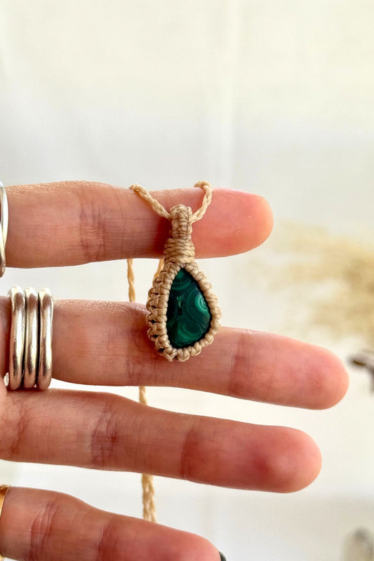 Hand holding a handmade Malachite Macrame necklace from the Essence collection, featuring a high-quality gemstone in a delicate everyday-wear design.