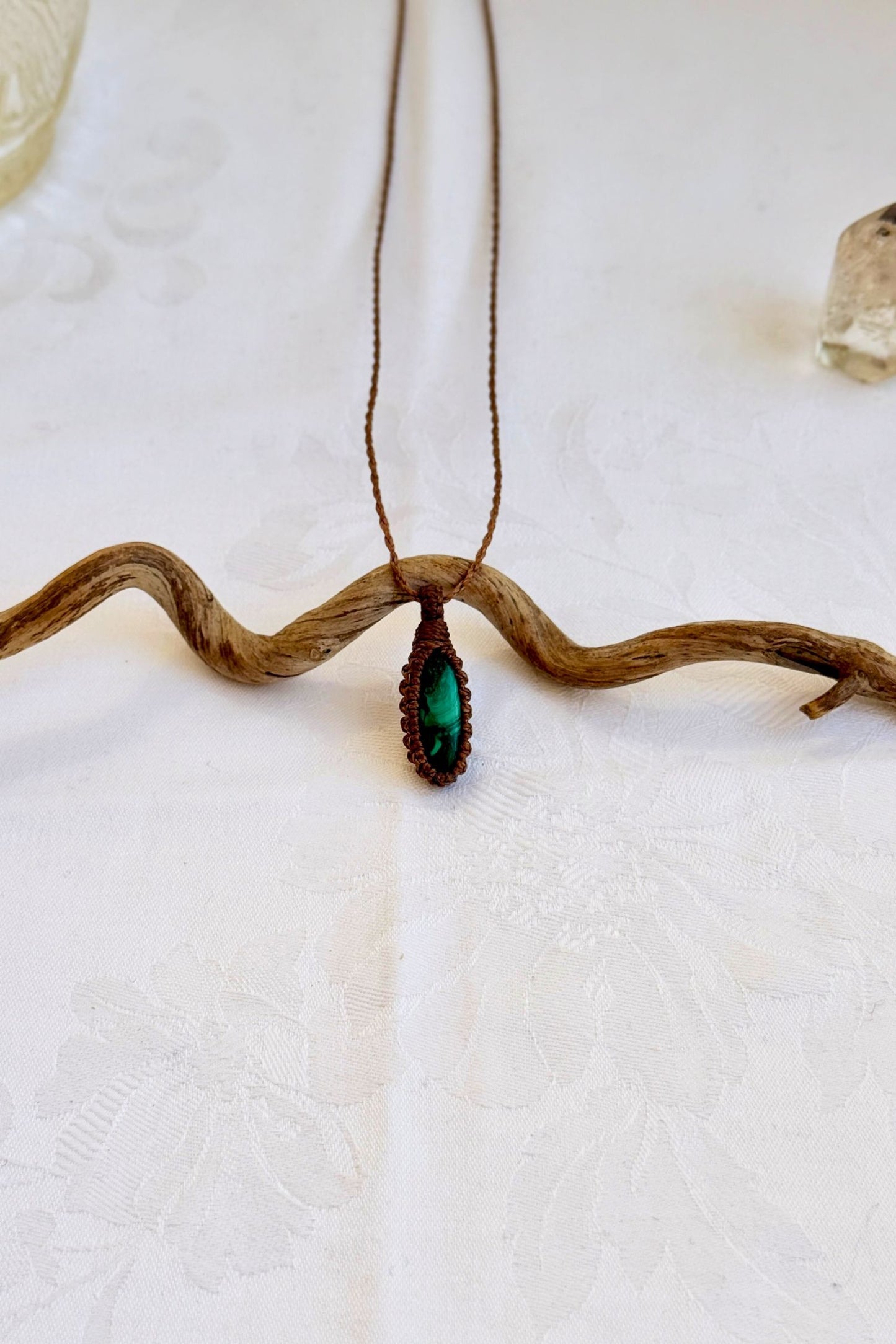 Handmade Malachite Macrame necklace featuring a high-quality gemstone, laid flat to showcase its delicate everyday-wear design from the Essence collection.