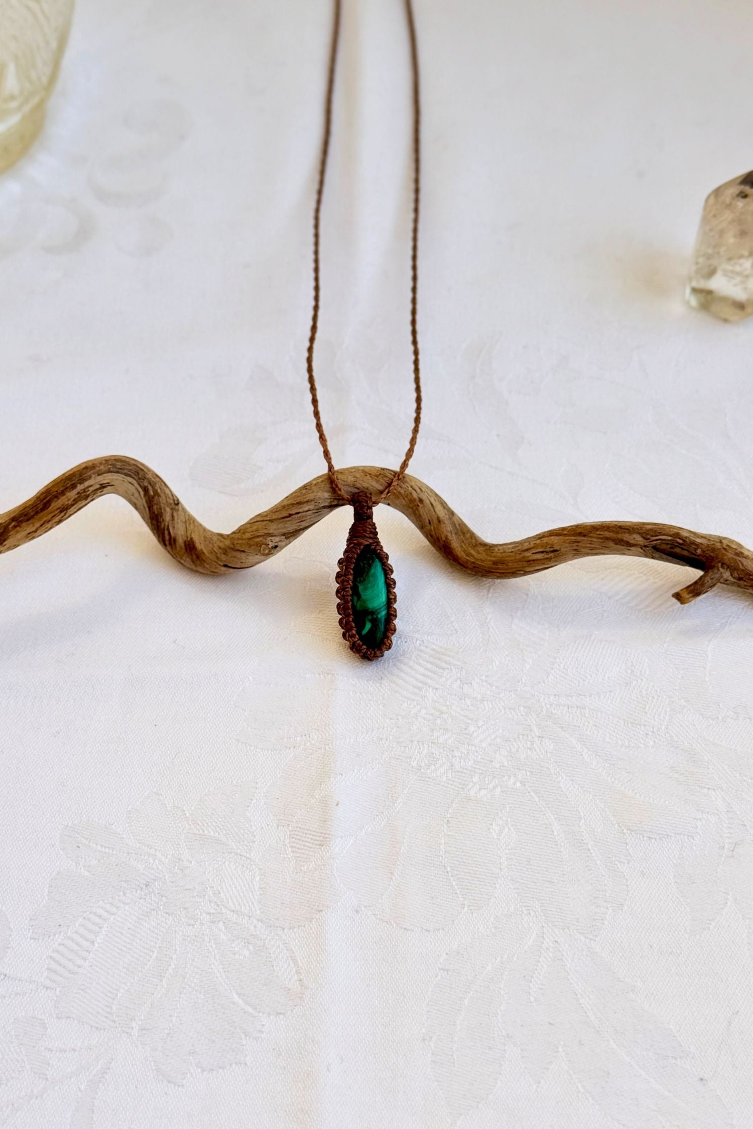 Handmade Malachite Macrame necklace featuring a high-quality gemstone, laid flat to showcase its delicate everyday-wear design from the Essence collection.