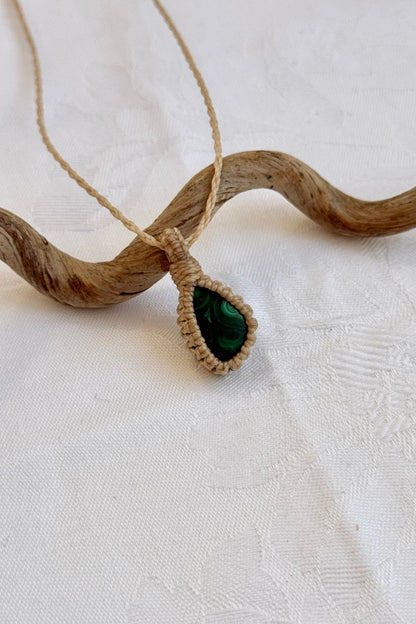 Close-up of handmade Malachite Macrame necklace, showcasing the intricate macrame knotting and the vibrant patterns of the gemstone.