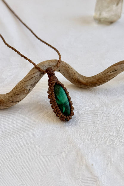 Close-up of handmade Malachite Macrame necklace, showcasing the intricate macrame knotting and the vibrant patterns of the gemstone.