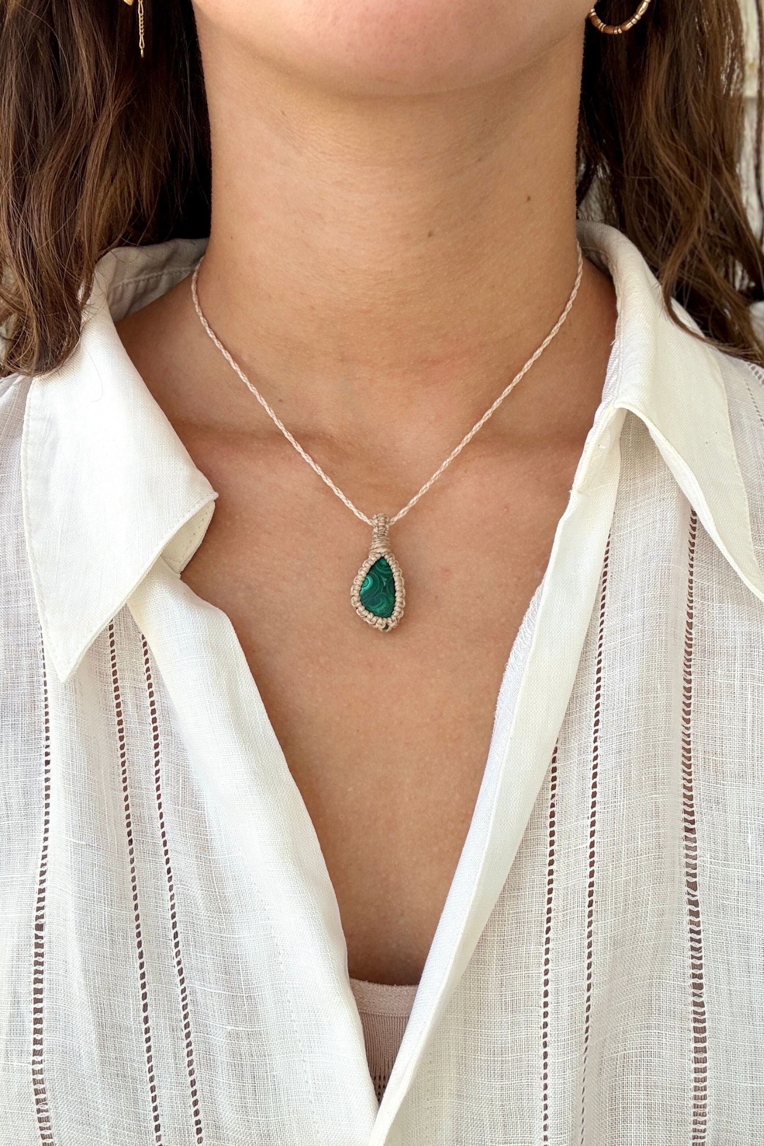 Model wearing a delicate handmade Malachite macrame necklace with a beige cord, perfect for everyday wear.