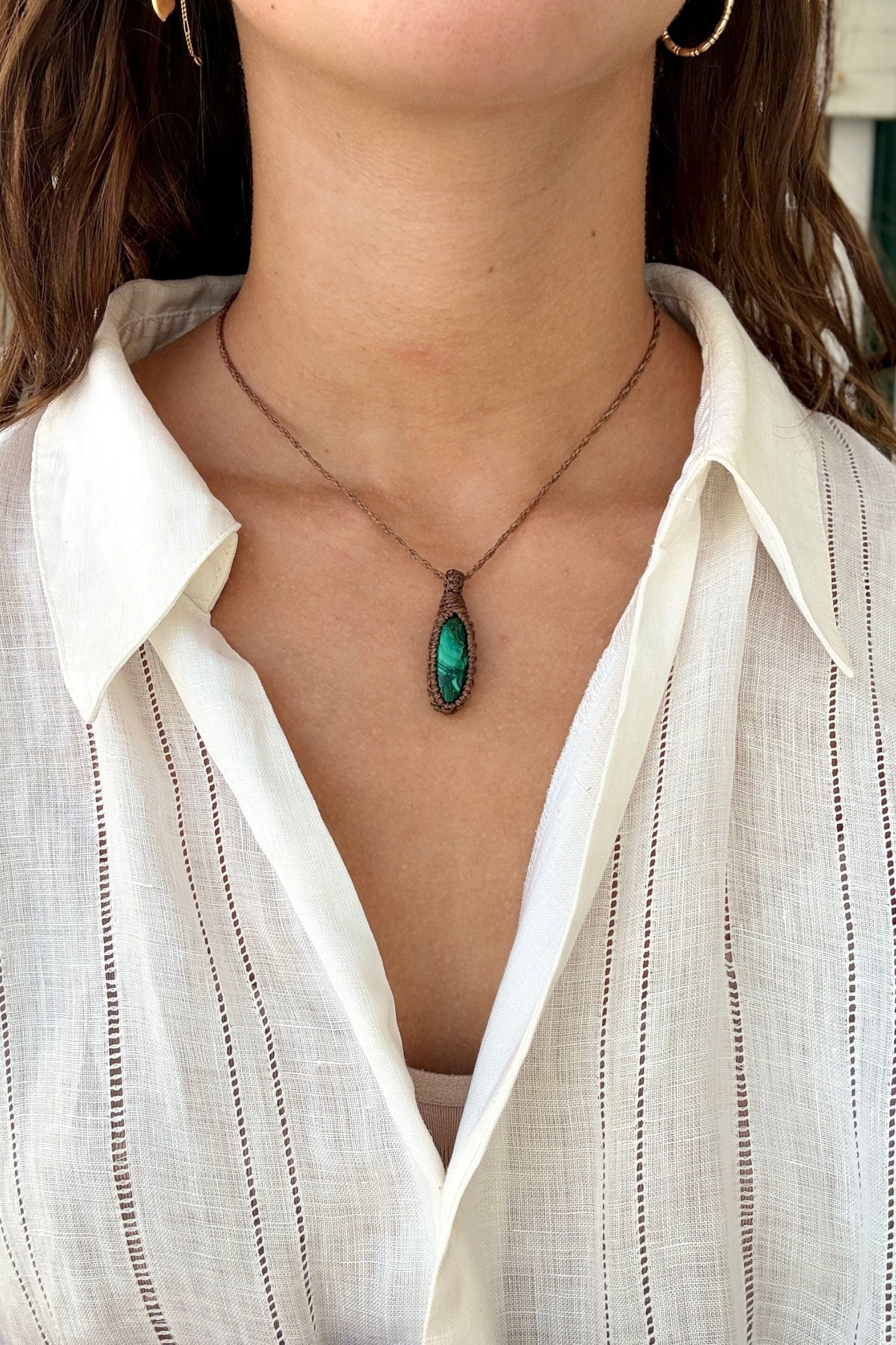 Model wearing a delicate handmade Malachite macrame necklace with a brown cord, perfect for everyday wear.