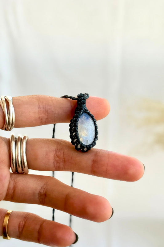 Hand holding a handmade Moonstone Macrame necklace from the Essence collection, featuring a high-quality gemstone in a delicate everyday-wear design.