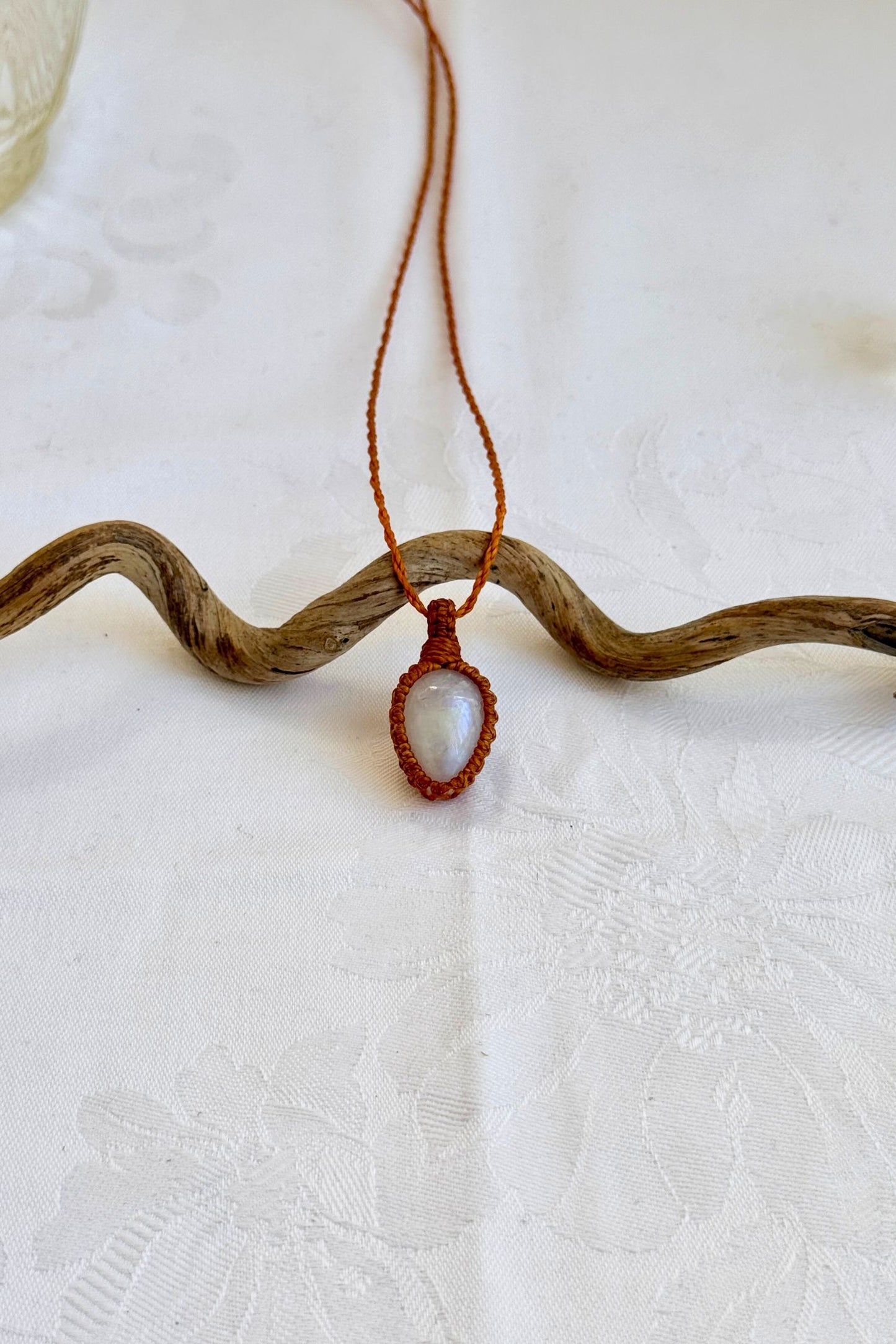 Handmade Moonstone Macrame necklace featuring a high-quality gemstone, laid flat to showcase its delicate everyday-wear design from the Essence collection.
