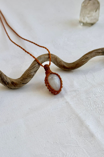 Side angle view of the Moonstone Macrame necklace, showing the fine macrame details and the unique gemstone centerpiece.