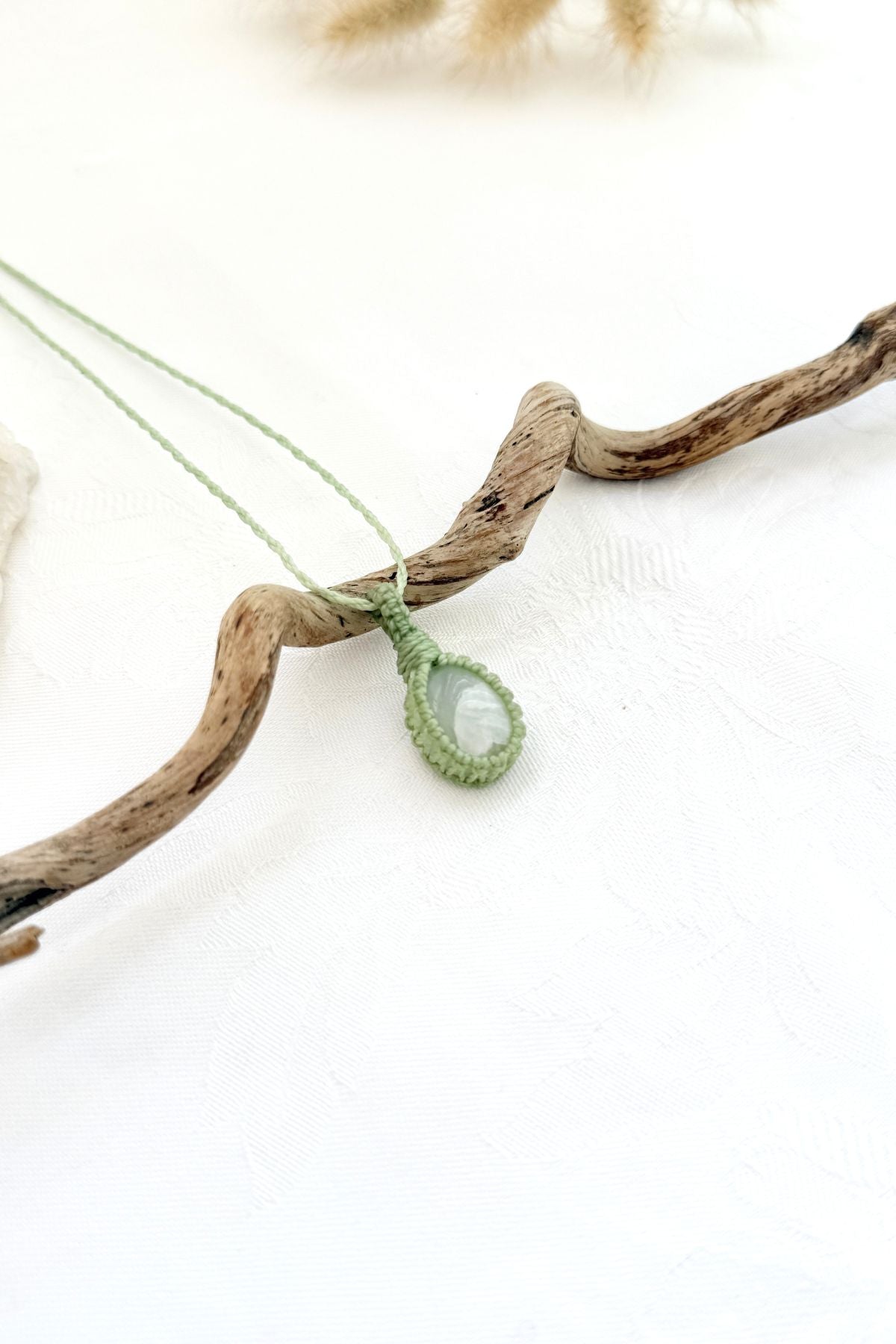 Handmade Moonstone macramé necklace, side view showing the gemstone and macramé knotting