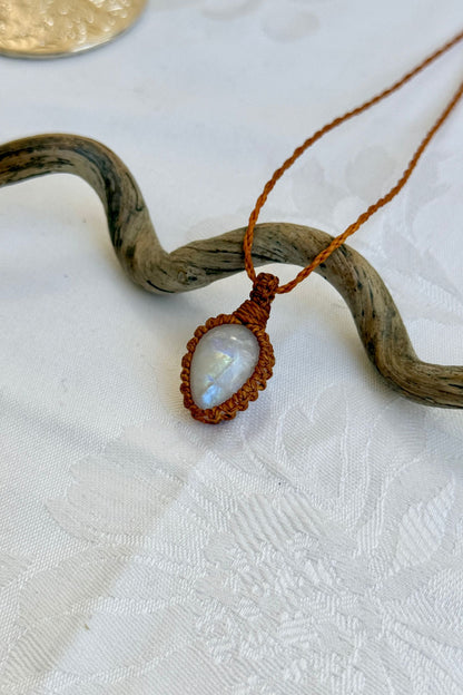 Close-up of handmade Moonstone Macrame necklace, showcasing the intricate macrame knotting and the vibrant patterns of the gemstone.