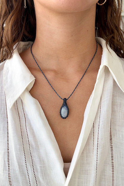 Model wearing a delicate handmade Moonstone macrame necklace with a naivy blue cord, perfect for everyday wear.