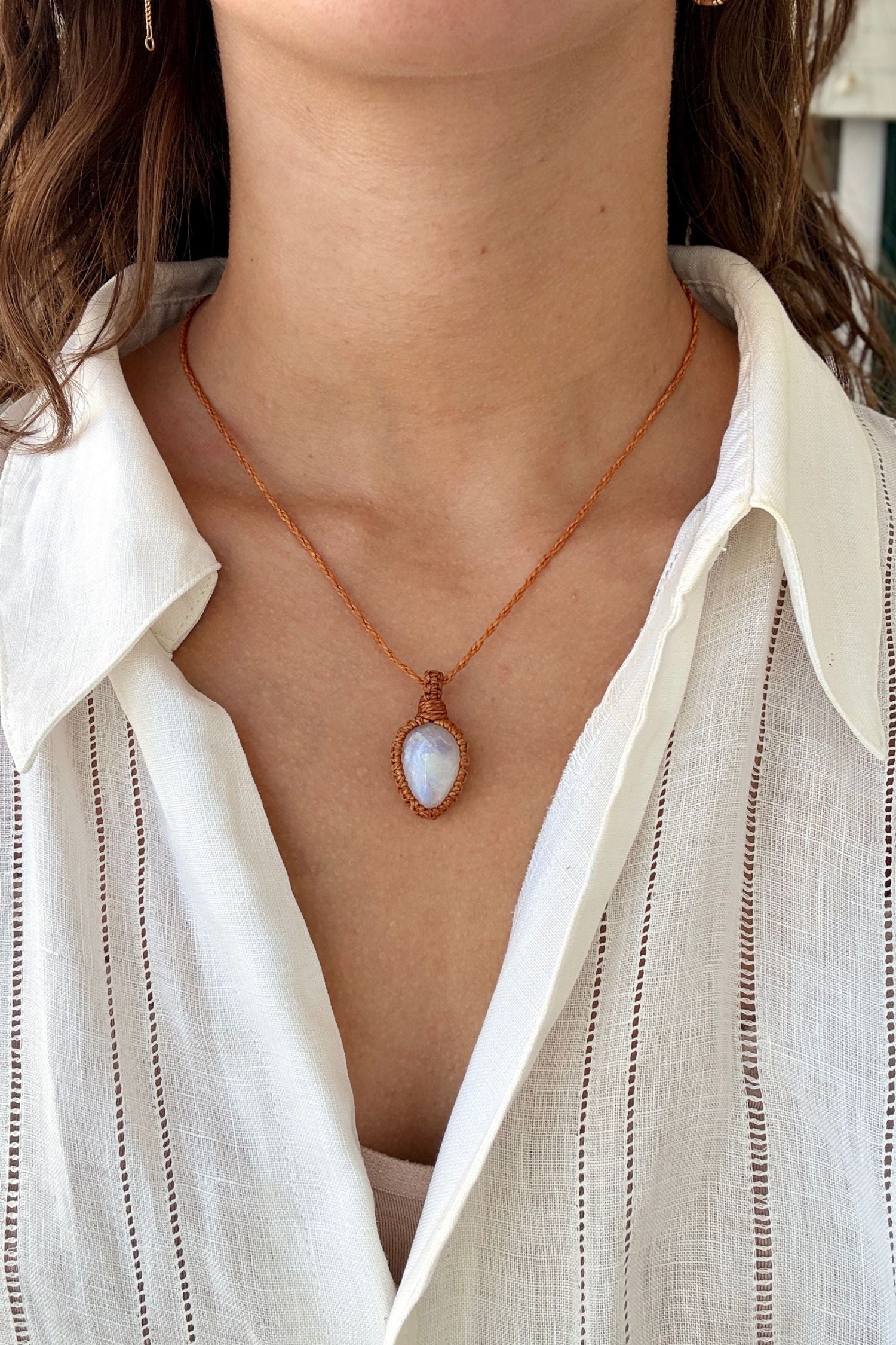 Model wearing a delicate handmade Moonstone macrame necklace with a orange cord, perfect for everyday wear.