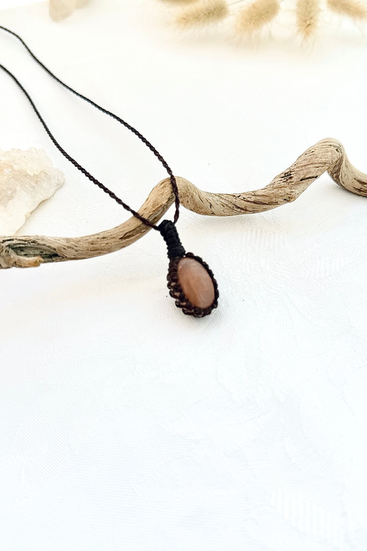 Handmade Peach Moonstone macramé necklace, side view showing the gemstone and macramé knotting