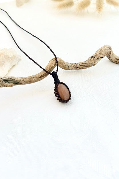 Handmade Peach Moonstone macramé necklace, side view showing the gemstone and macramé knotting