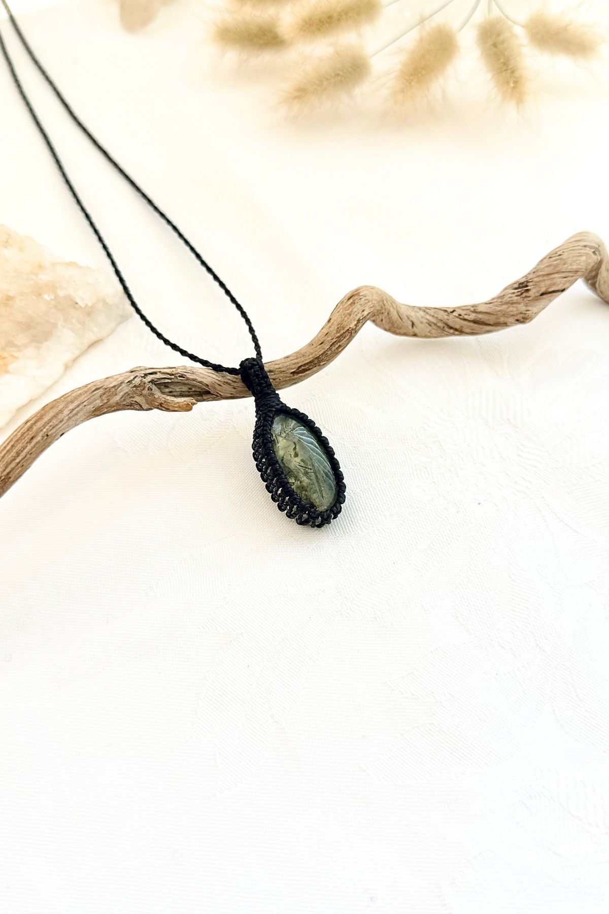 Handmade Prehnite macramé necklace, side view showing the gemstone and macramé knotting